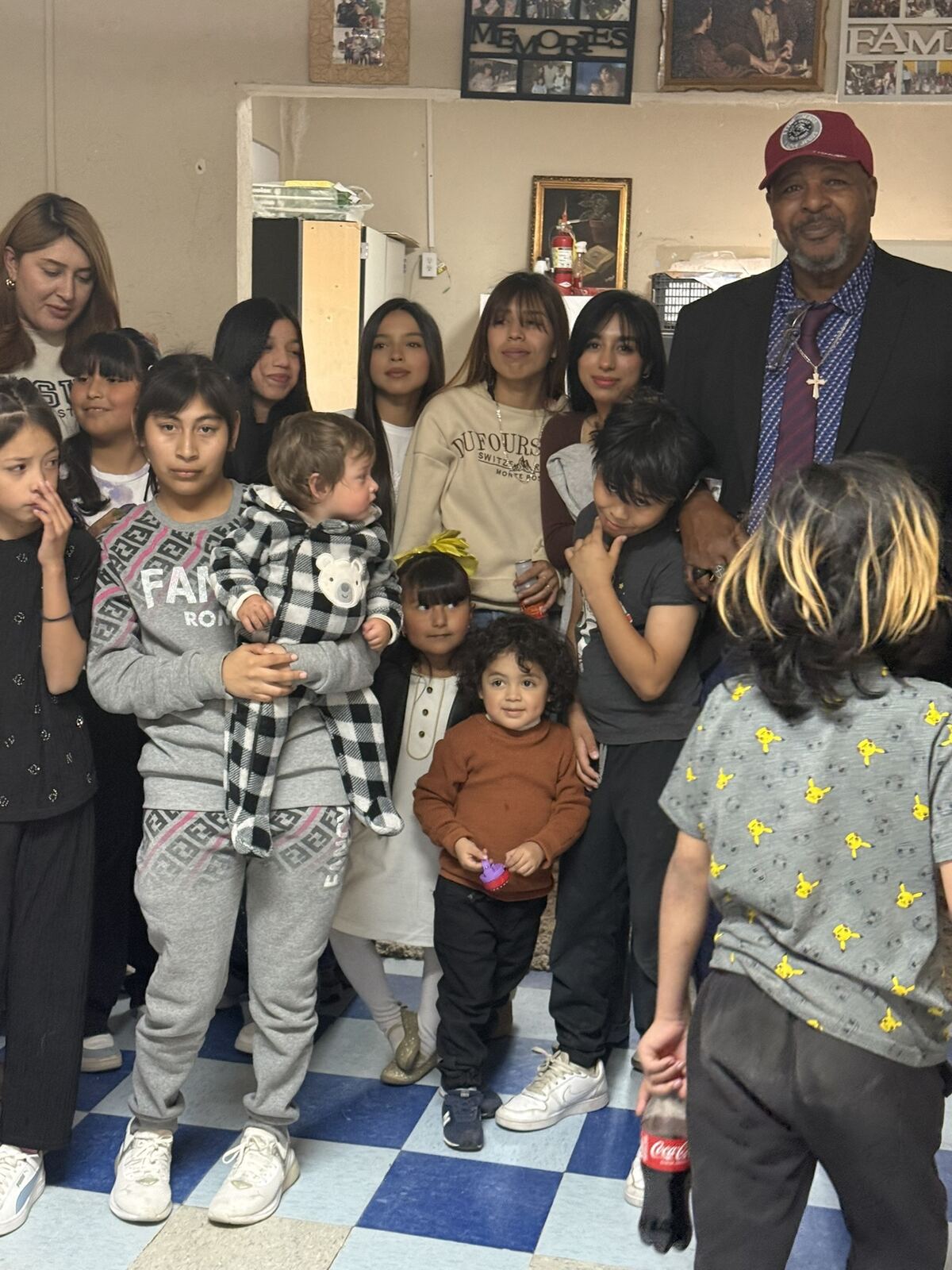 Pastor James Peoples standing with a large group of children and young people inside the church.